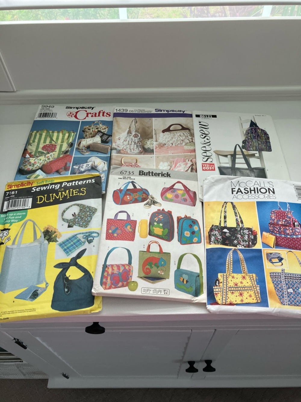 Six sewing patterns, craft bags, purses and backpacks uncut